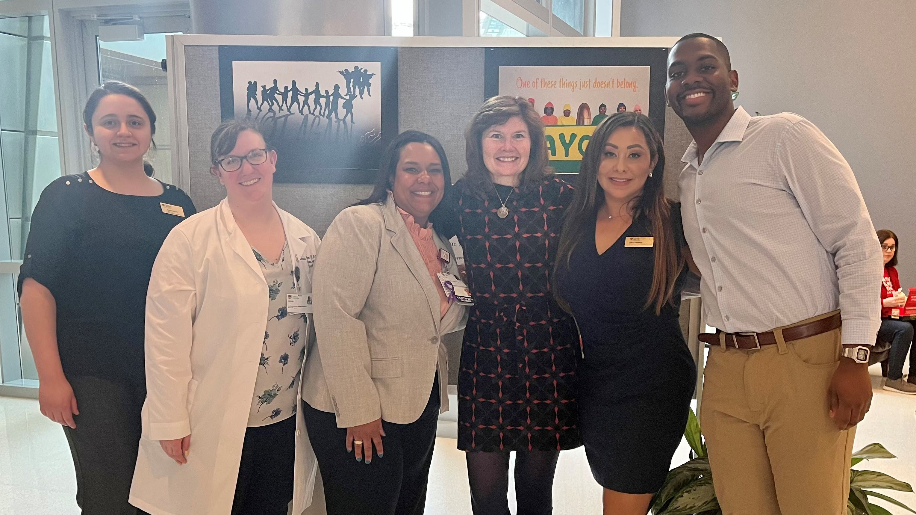 Group of Summit speakers and planners smiling at the camera